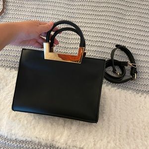 New black handbag with golden detail